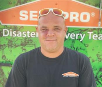 White male.  Smiling.  Wearing sunglasses on his head.