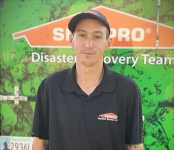 White male.  Wearing a black SERVPRO baseball cap.