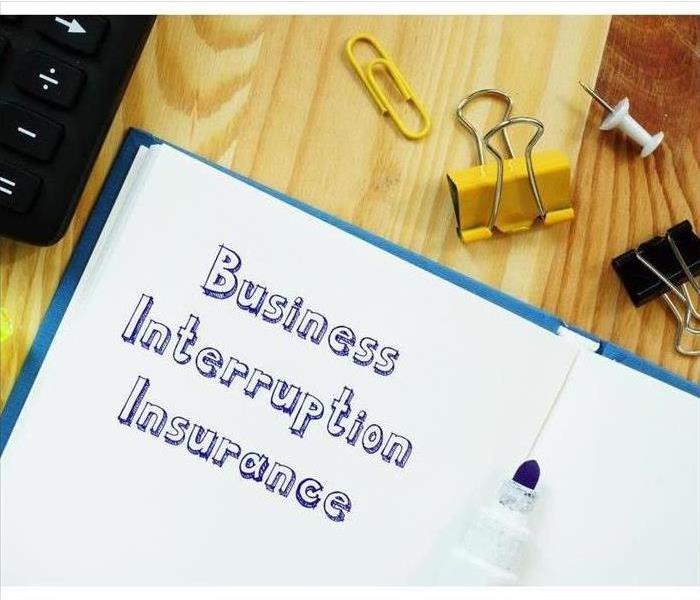 White paper that says 'business interruption insurance' on it